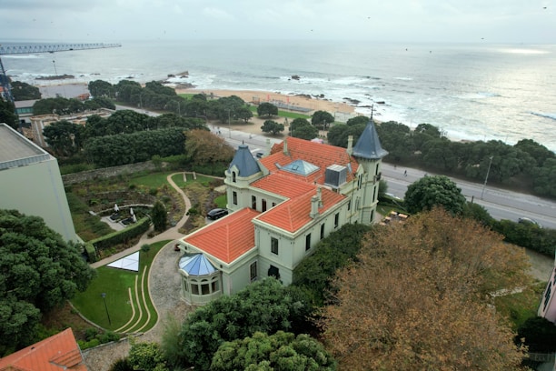 An aerial view of a large building with a red roof