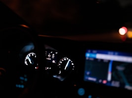 The dashboard of a car at night time