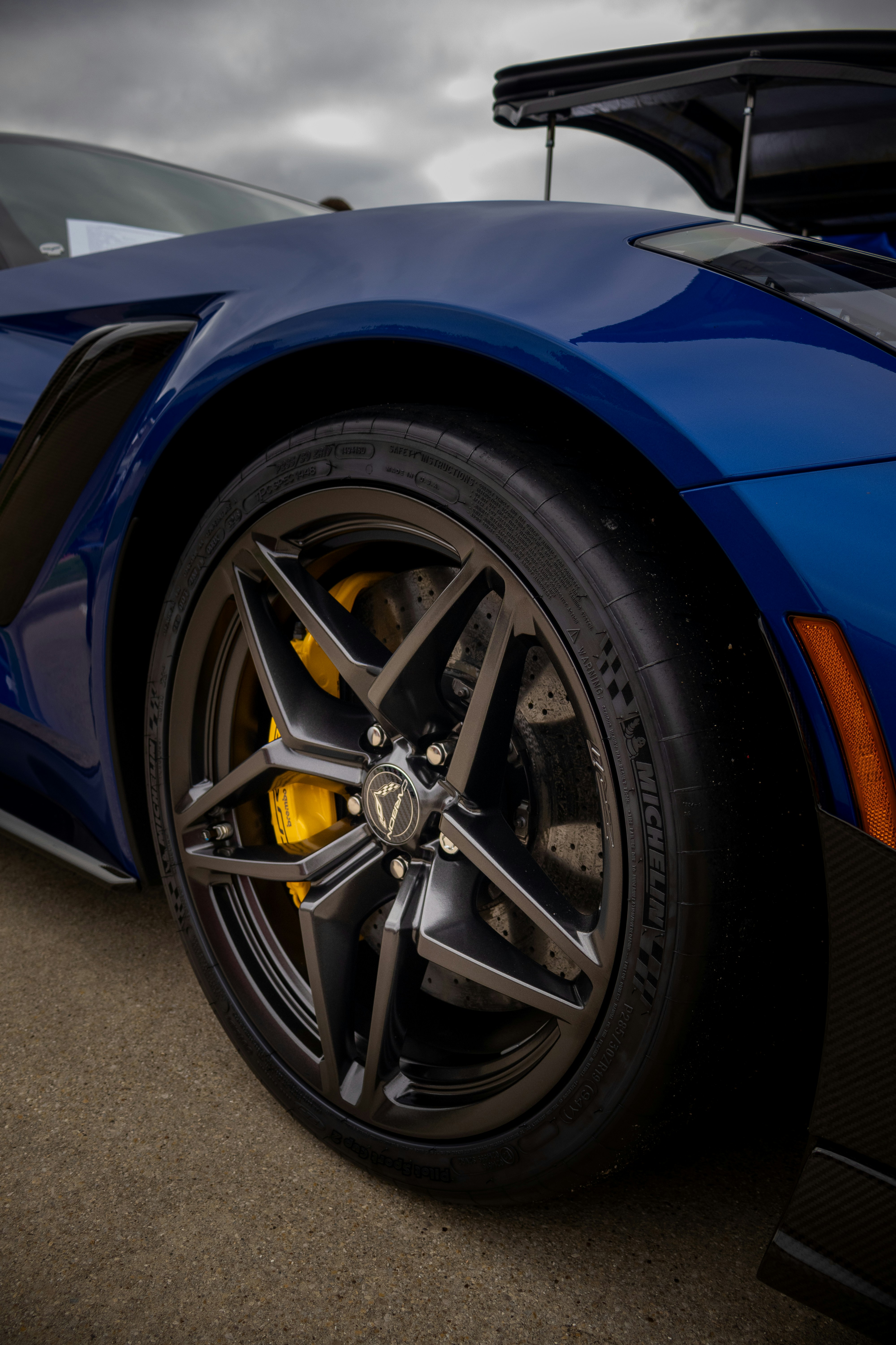 A blue sports car parked in a parking lot
