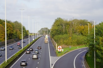A highway with a bunch of cars driving down it