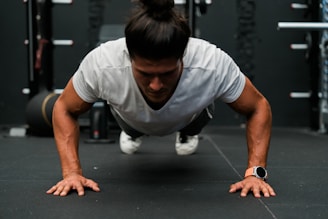 A man doing push ups in a gym