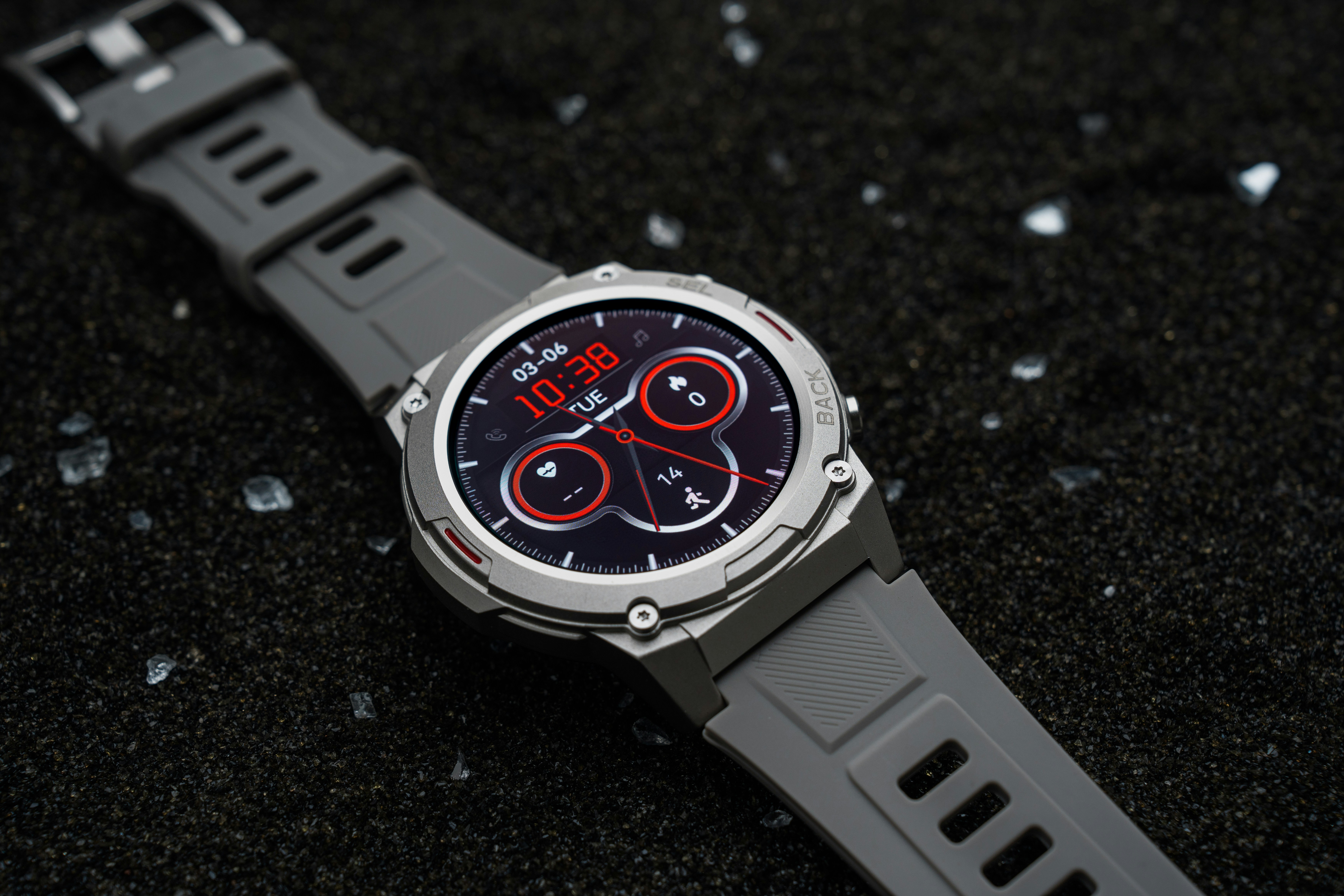 A close up of a watch on a black surface