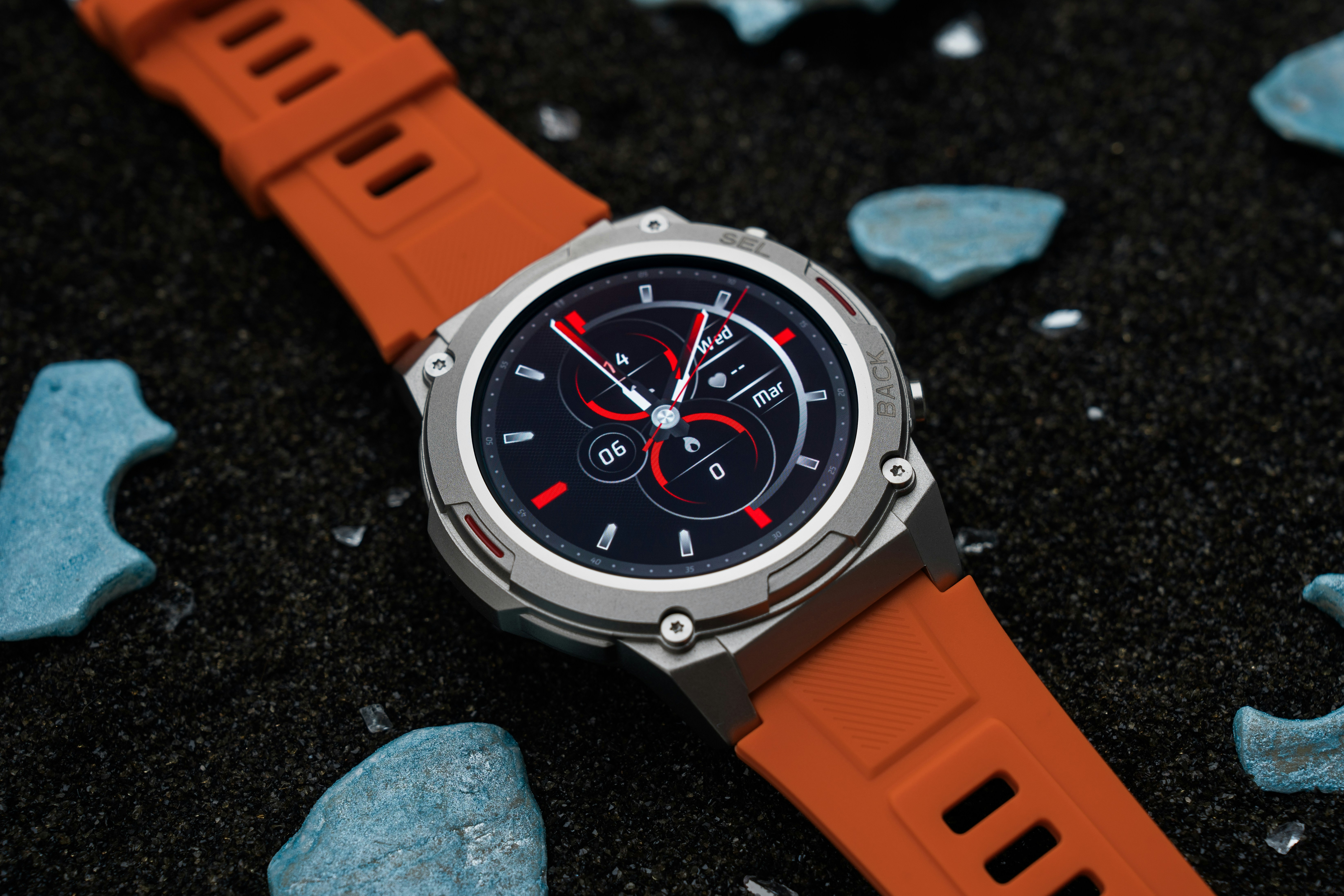 A watch sitting on top of a black surface