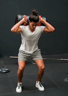A man lifting a barbell over his head