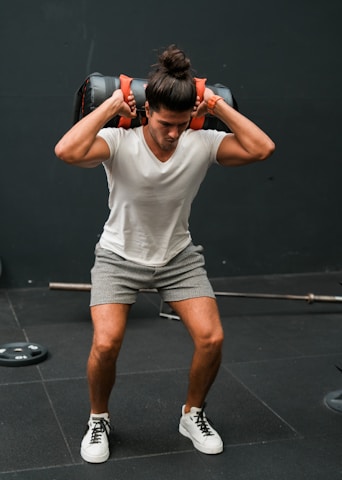 A man lifting a barbell over his head
