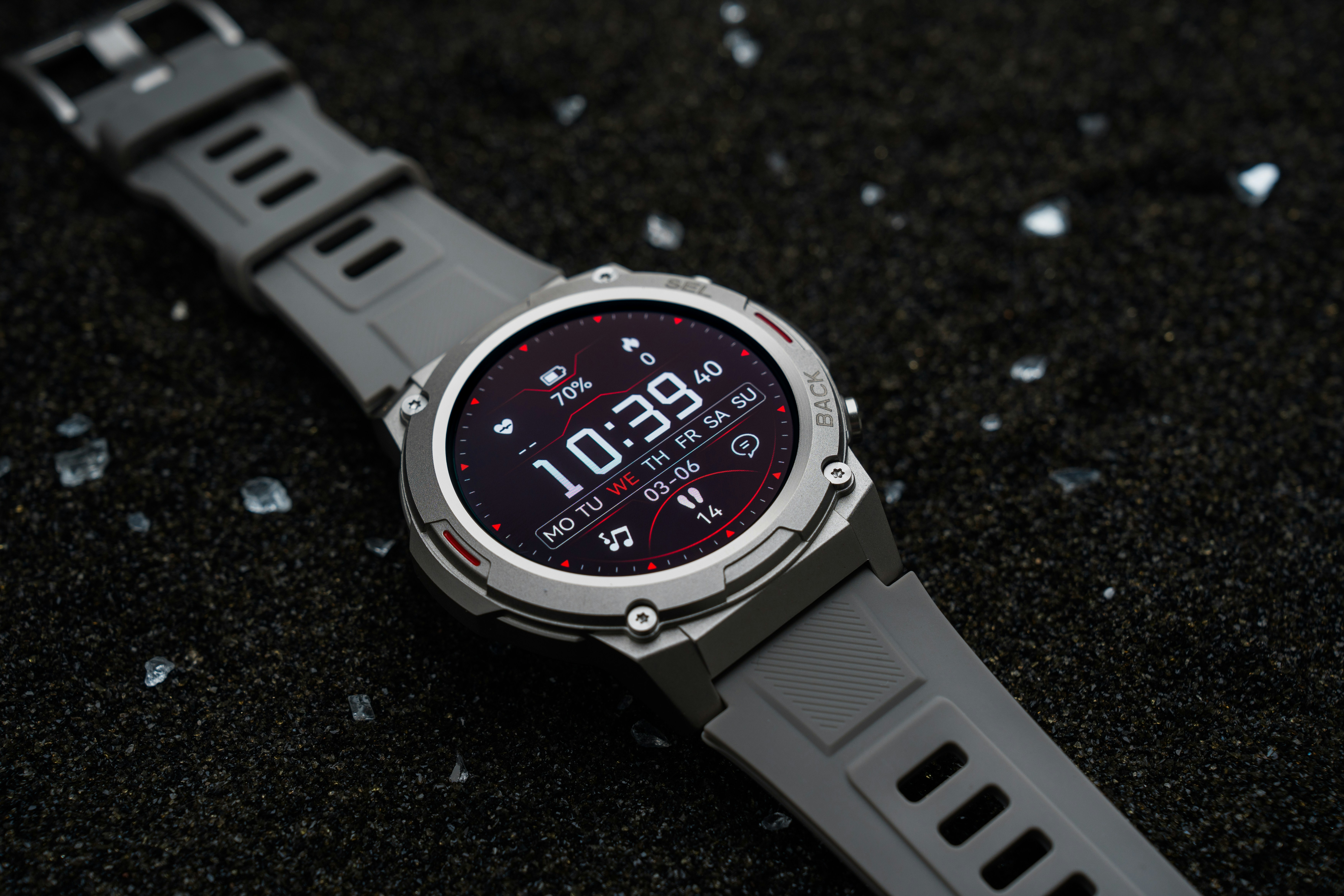 A close up of a watch on a black surface