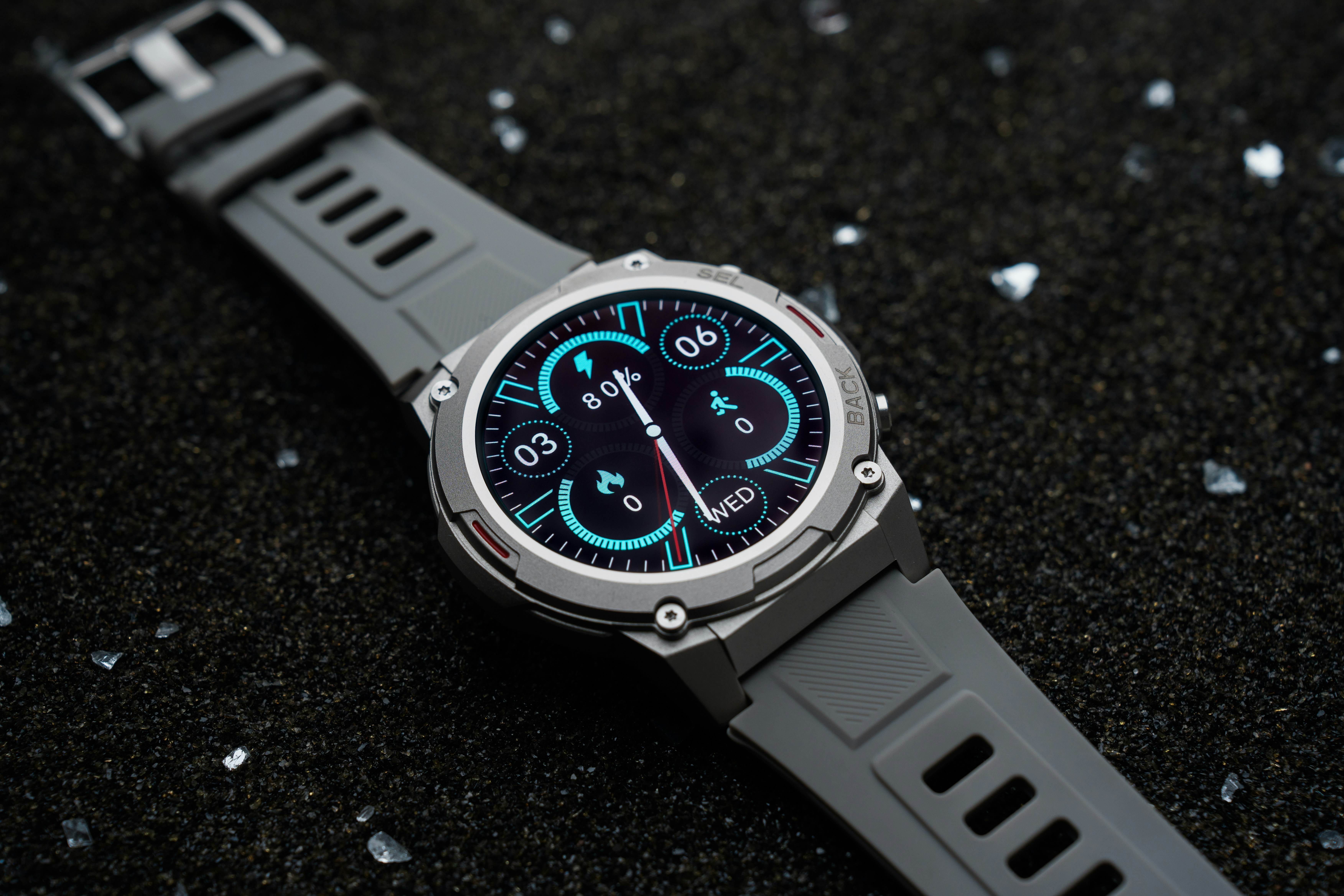 A watch sitting on top of a black surface