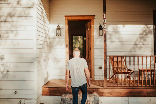 A man standing on the porch of a house