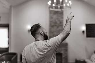 A man standing in a living room holding a remote