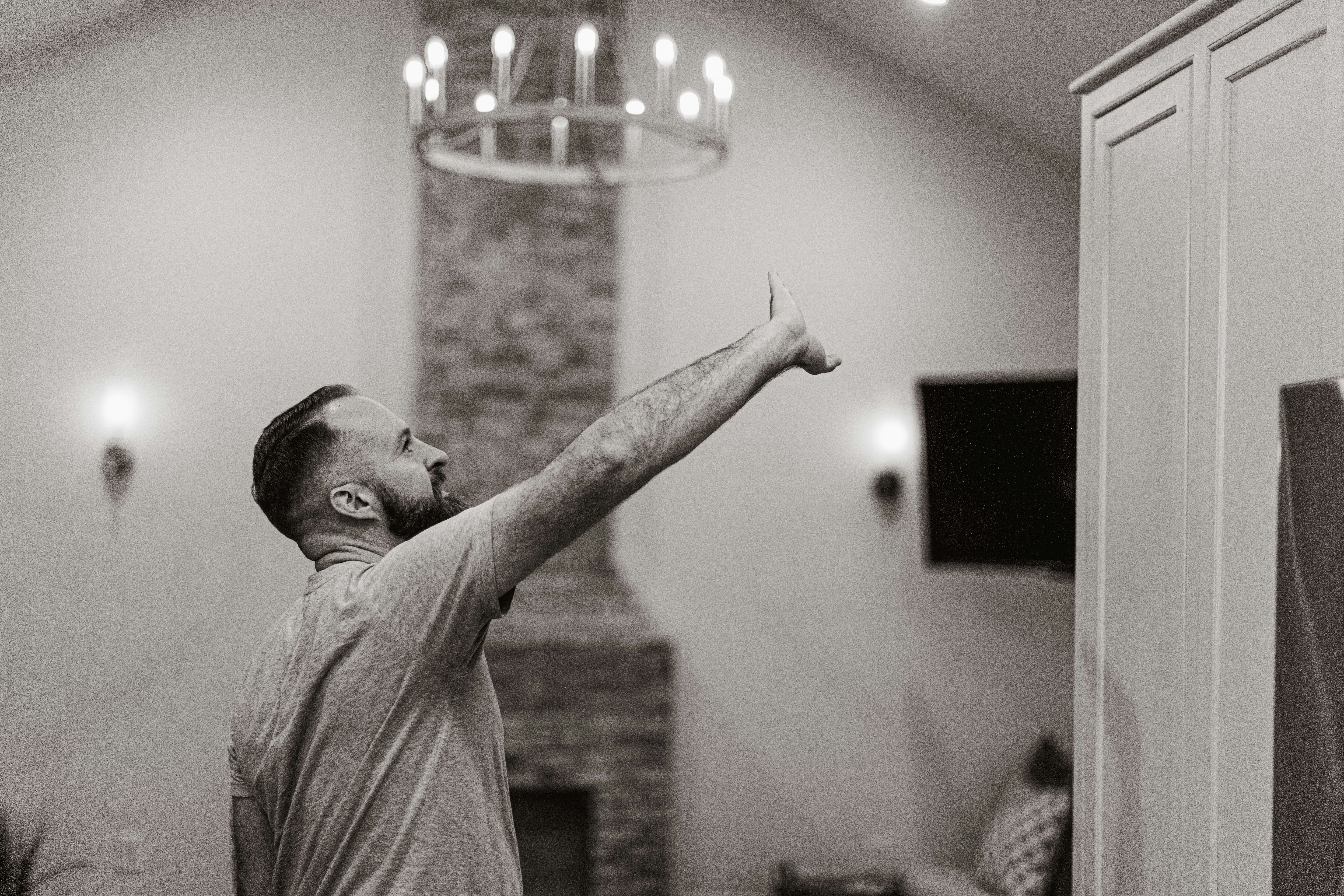 an appraiser inspecting a home heating system in a tidy basement utility room
