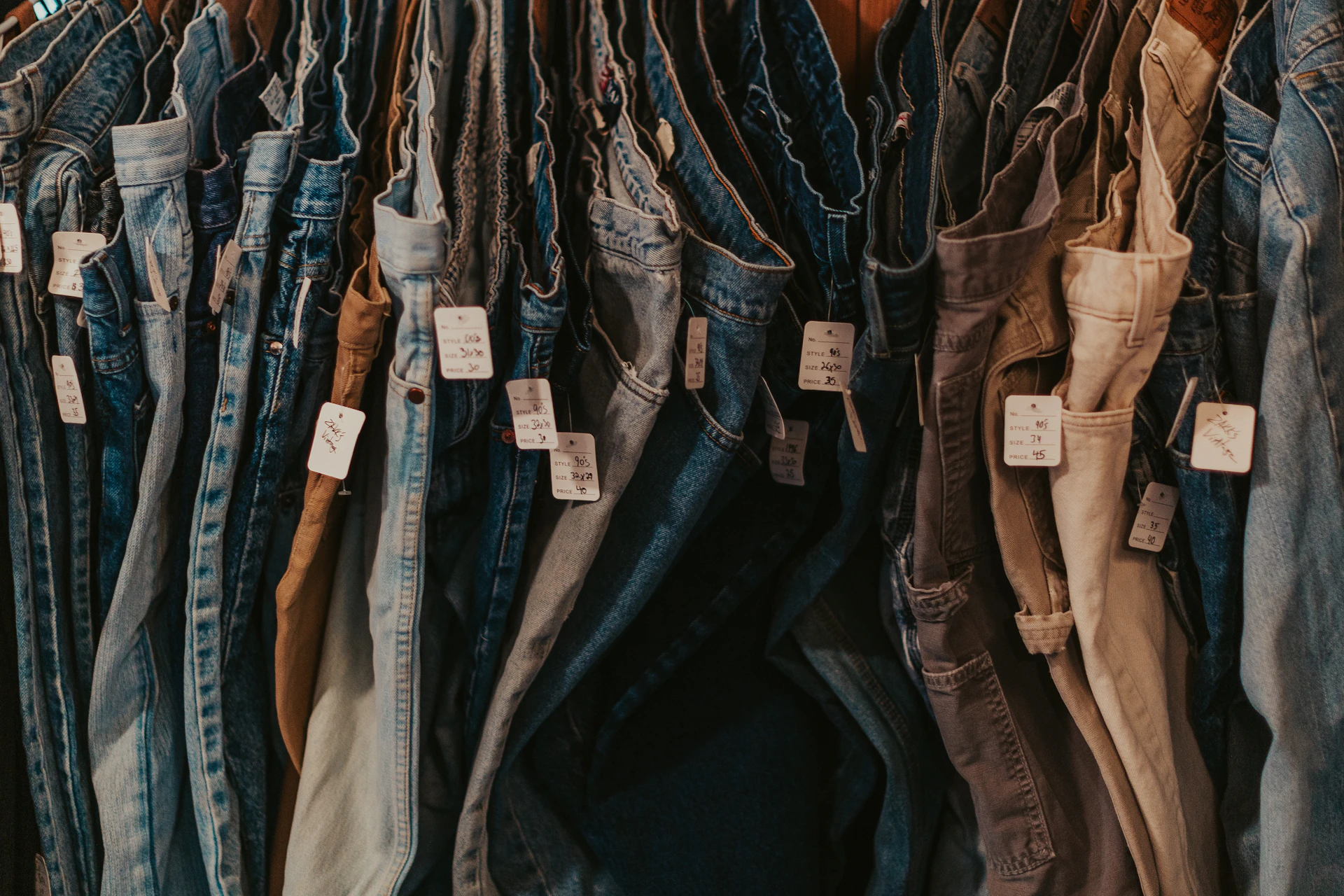 A rack of jeans hanging on a wall