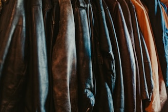 A row of leather jackets hanging on a rack