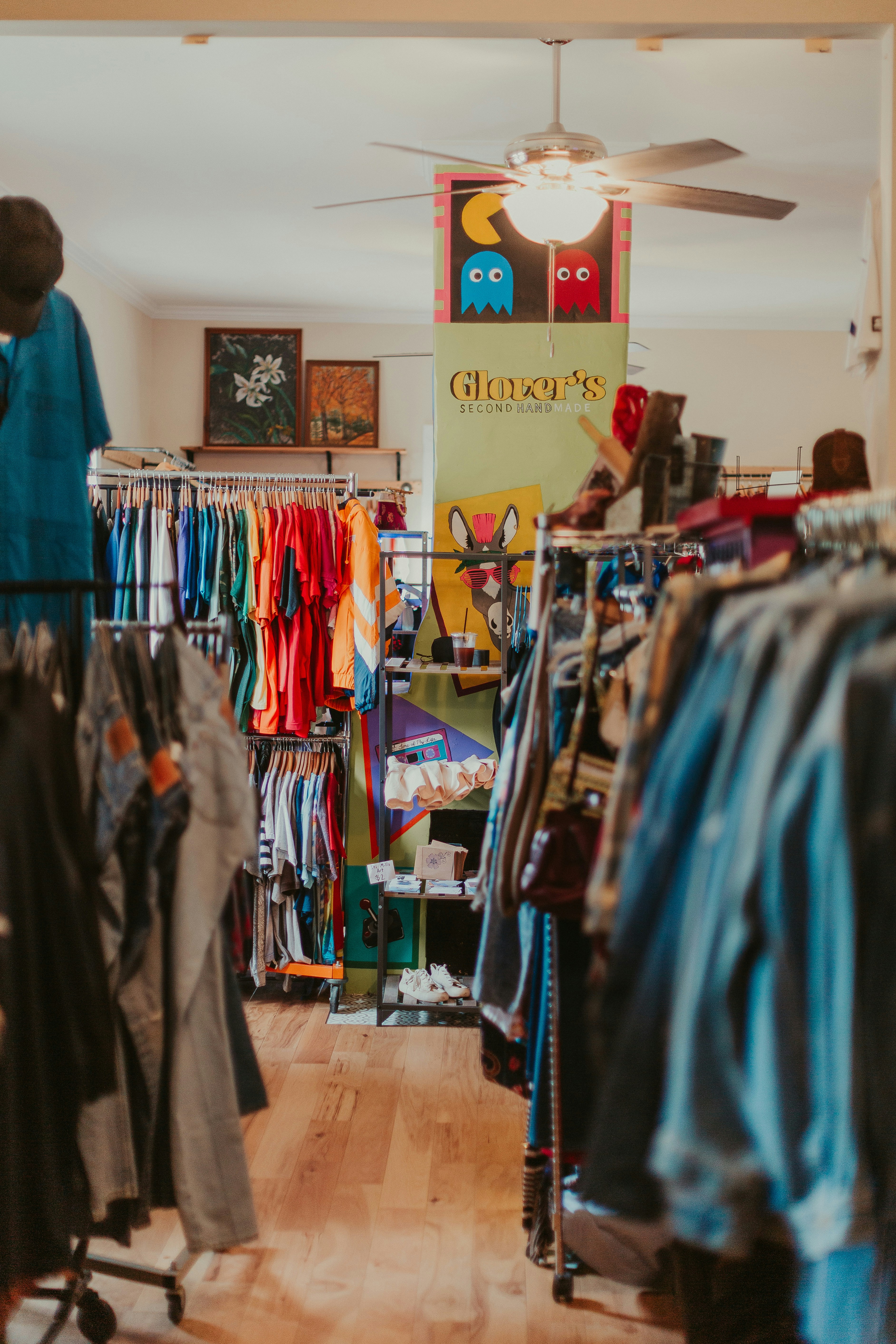 Organized clothing store with colorful jeans and apparel on racks, bright retail environment