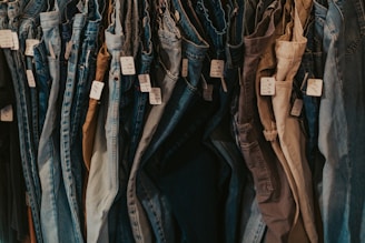 A rack of jeans hanging on a wall