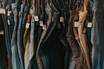 A rack of jeans hanging on a wall