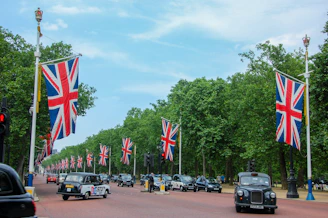 A street filled with lots of cars and UK flags