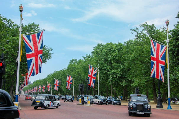 A street filled with lots of cars and UK flags