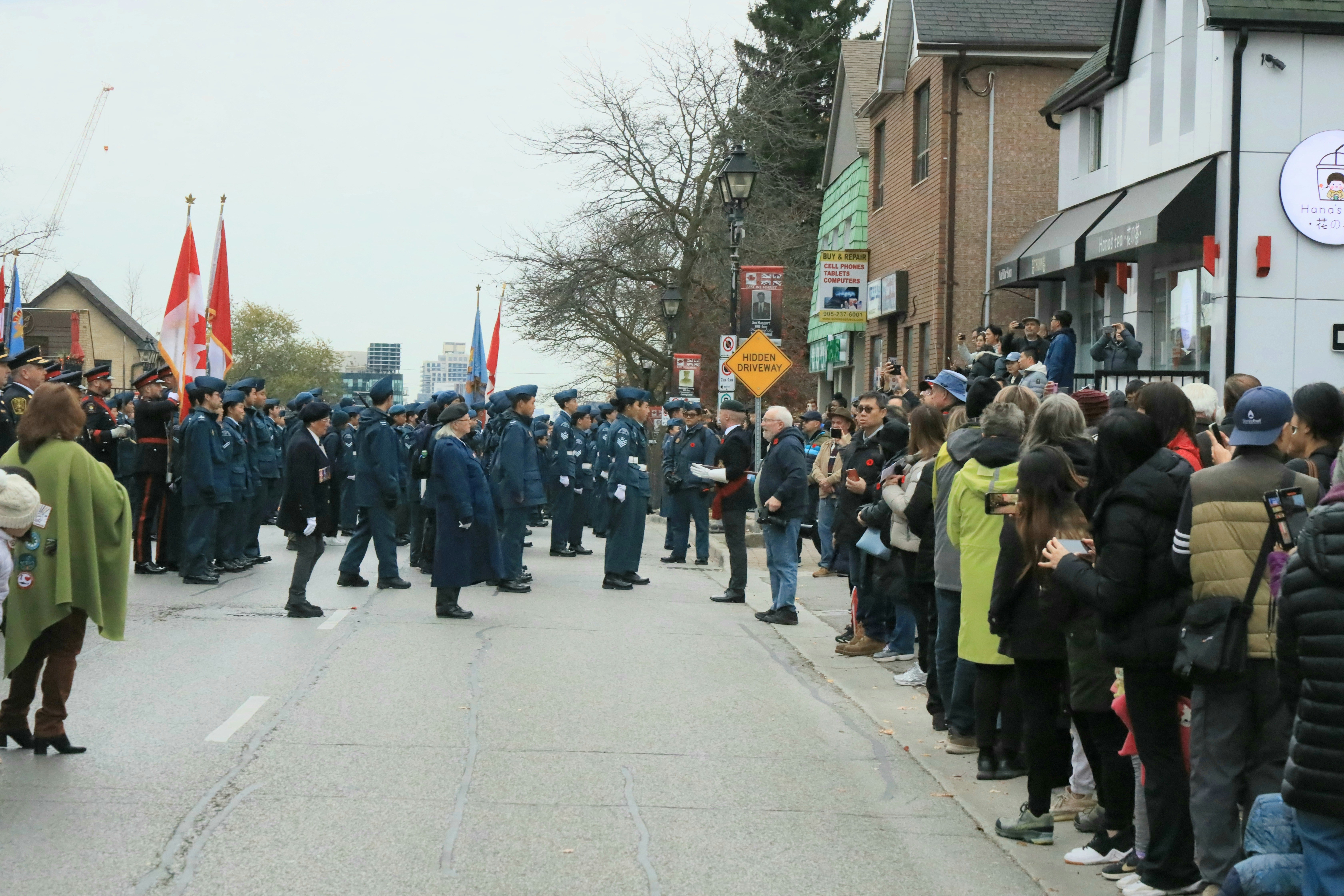 A crowd of people standing on the side of a road
