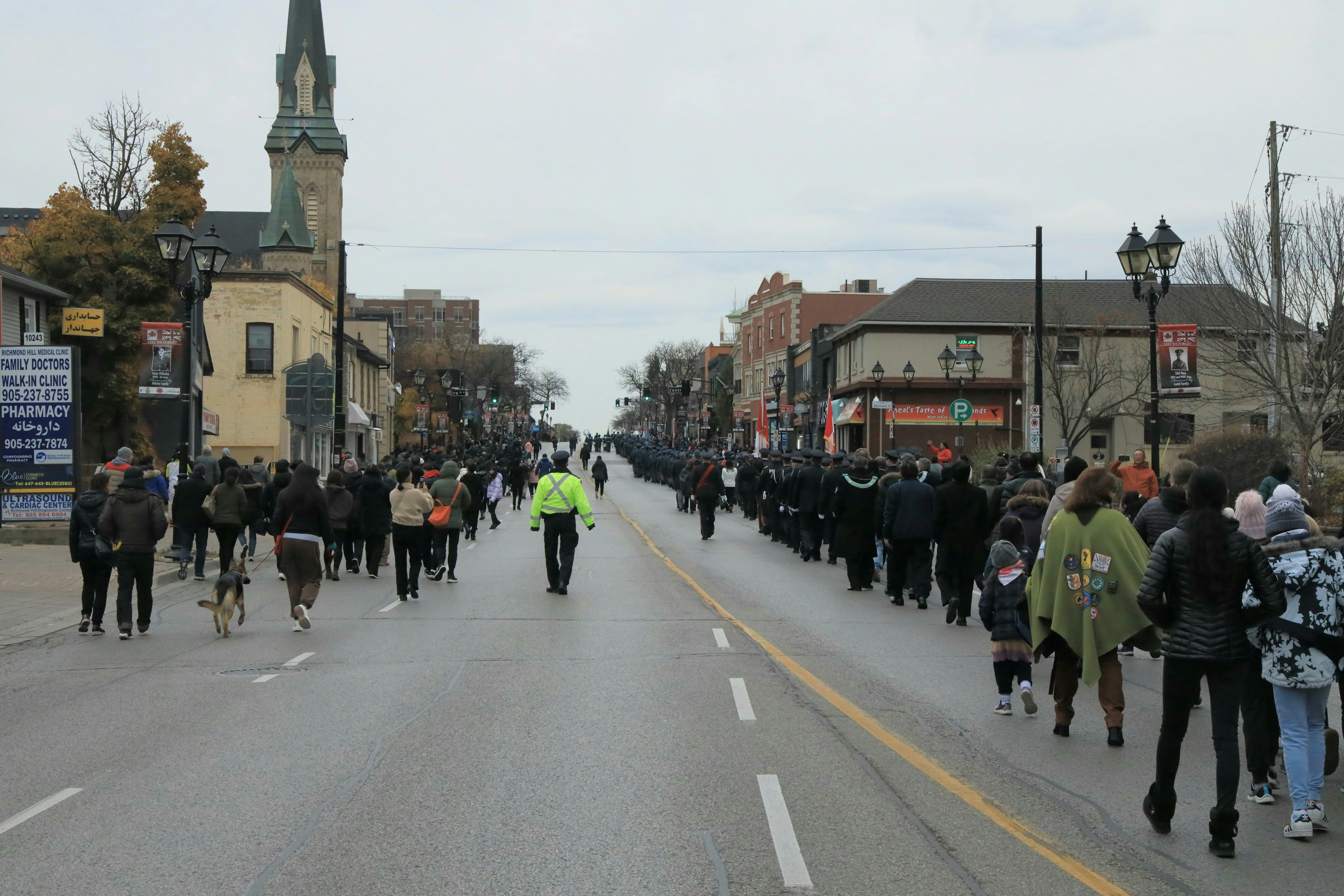A large group of people walking down a street