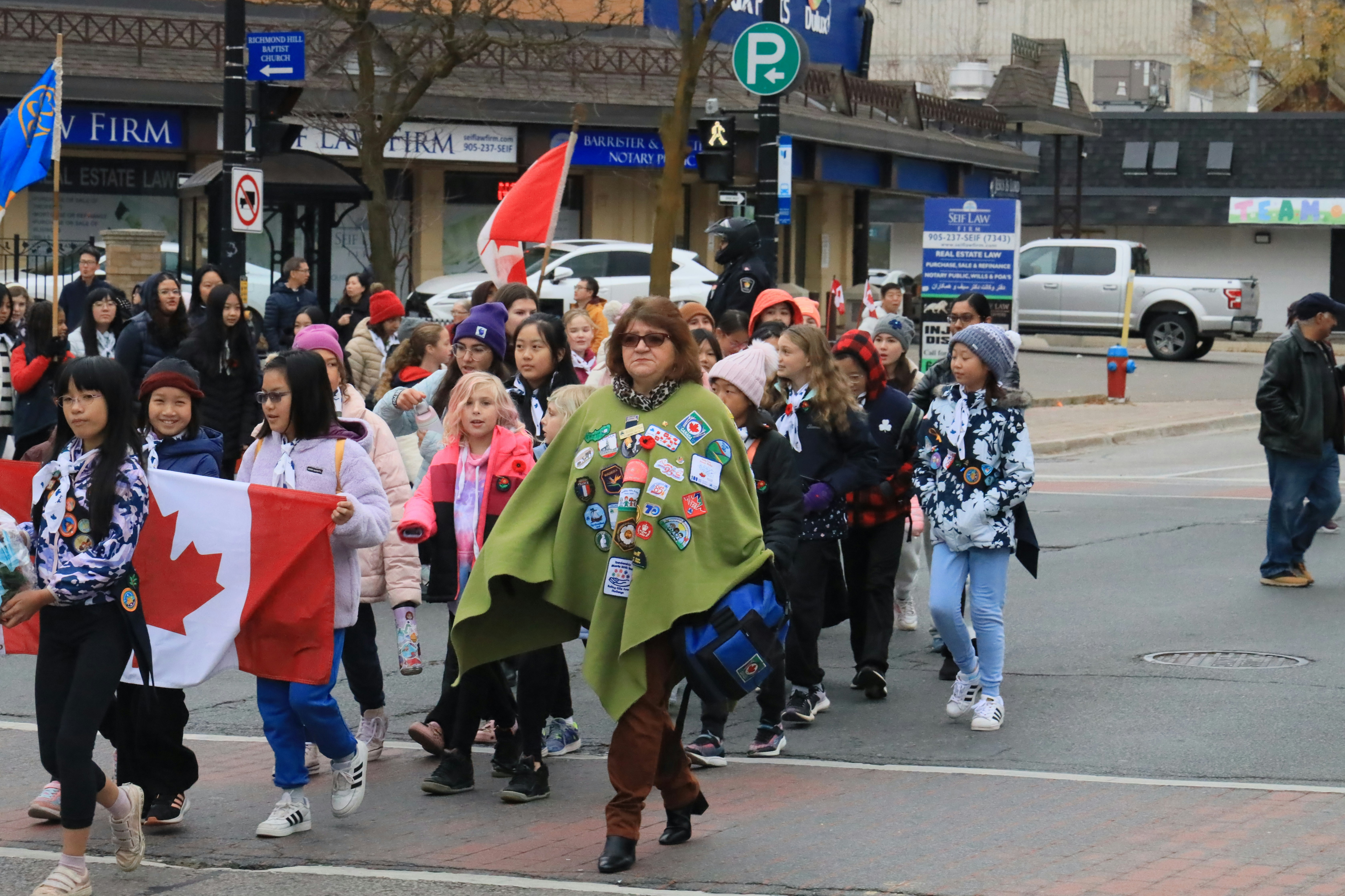 A large group of people walking down a street