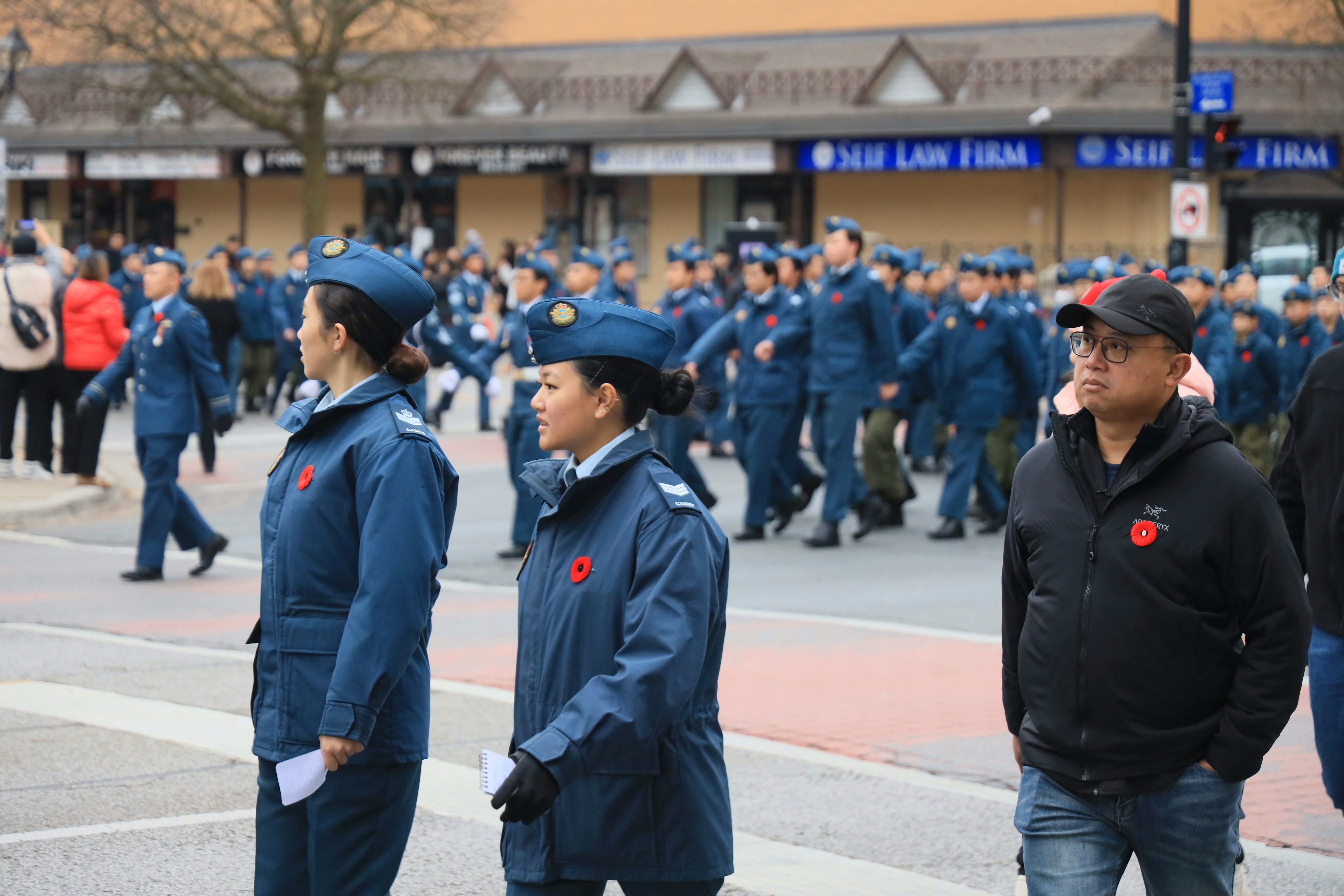A group of people standing on the side of a road