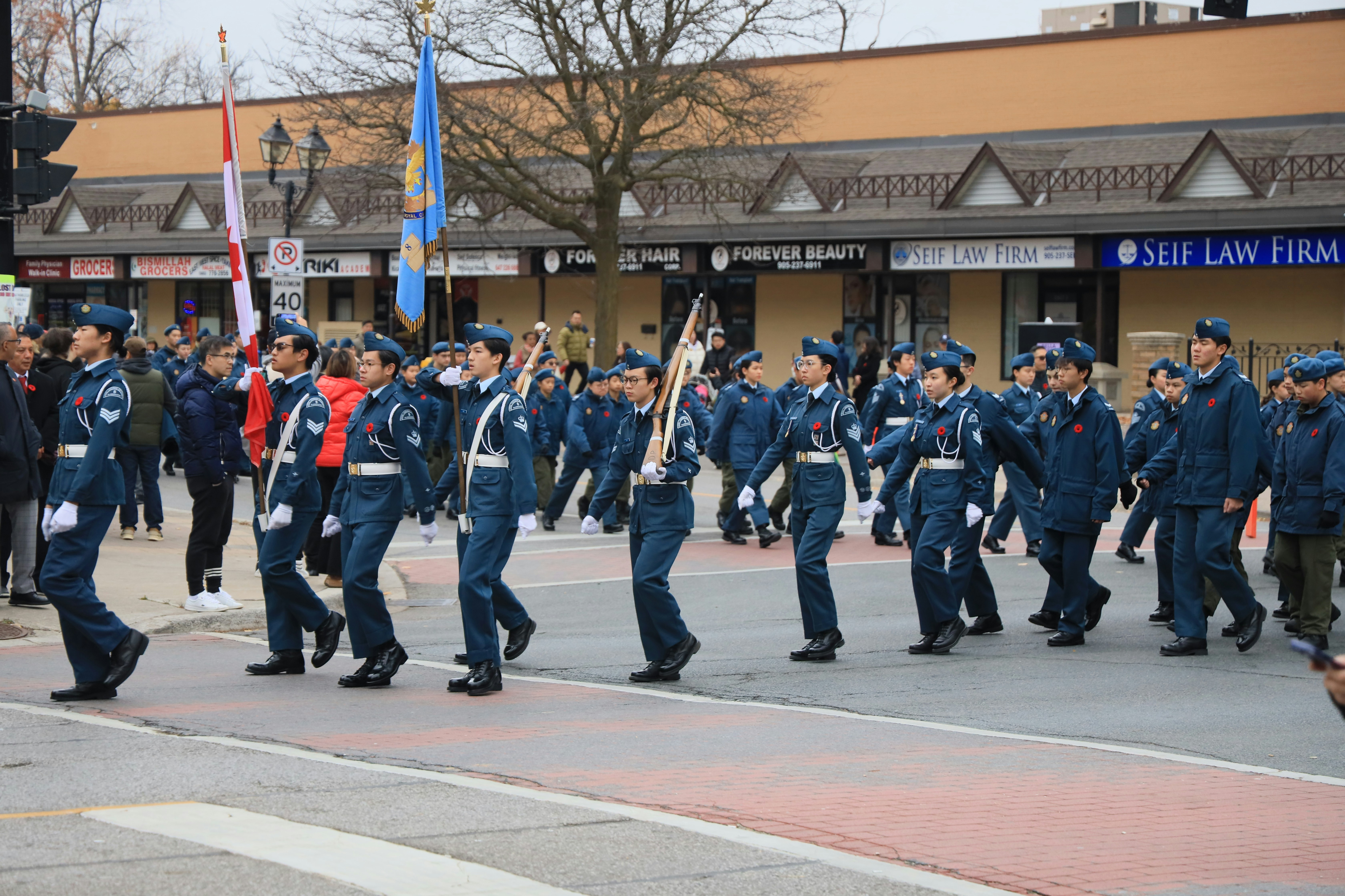 A group of police officers marching down a street