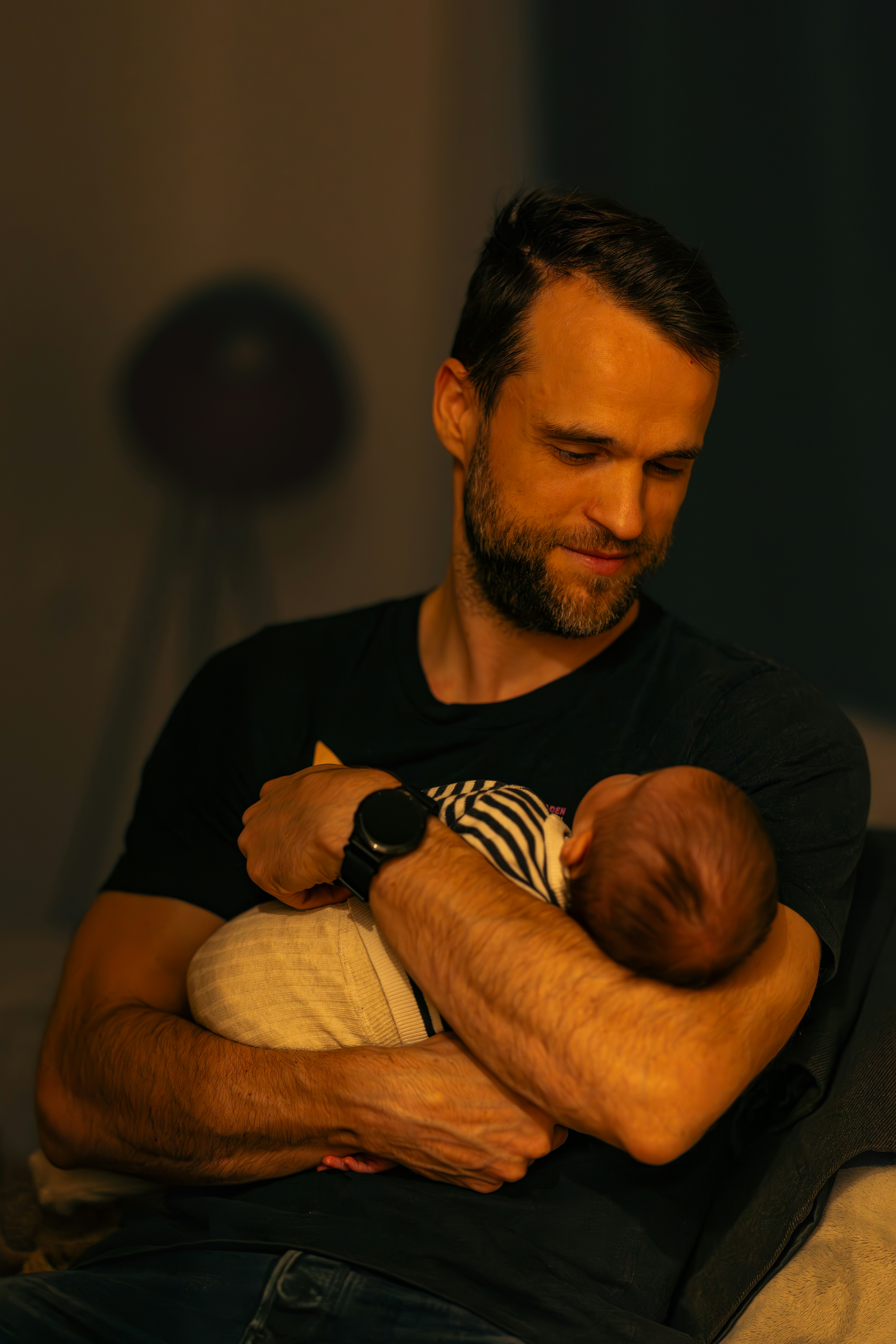 A man holding a baby in his arms