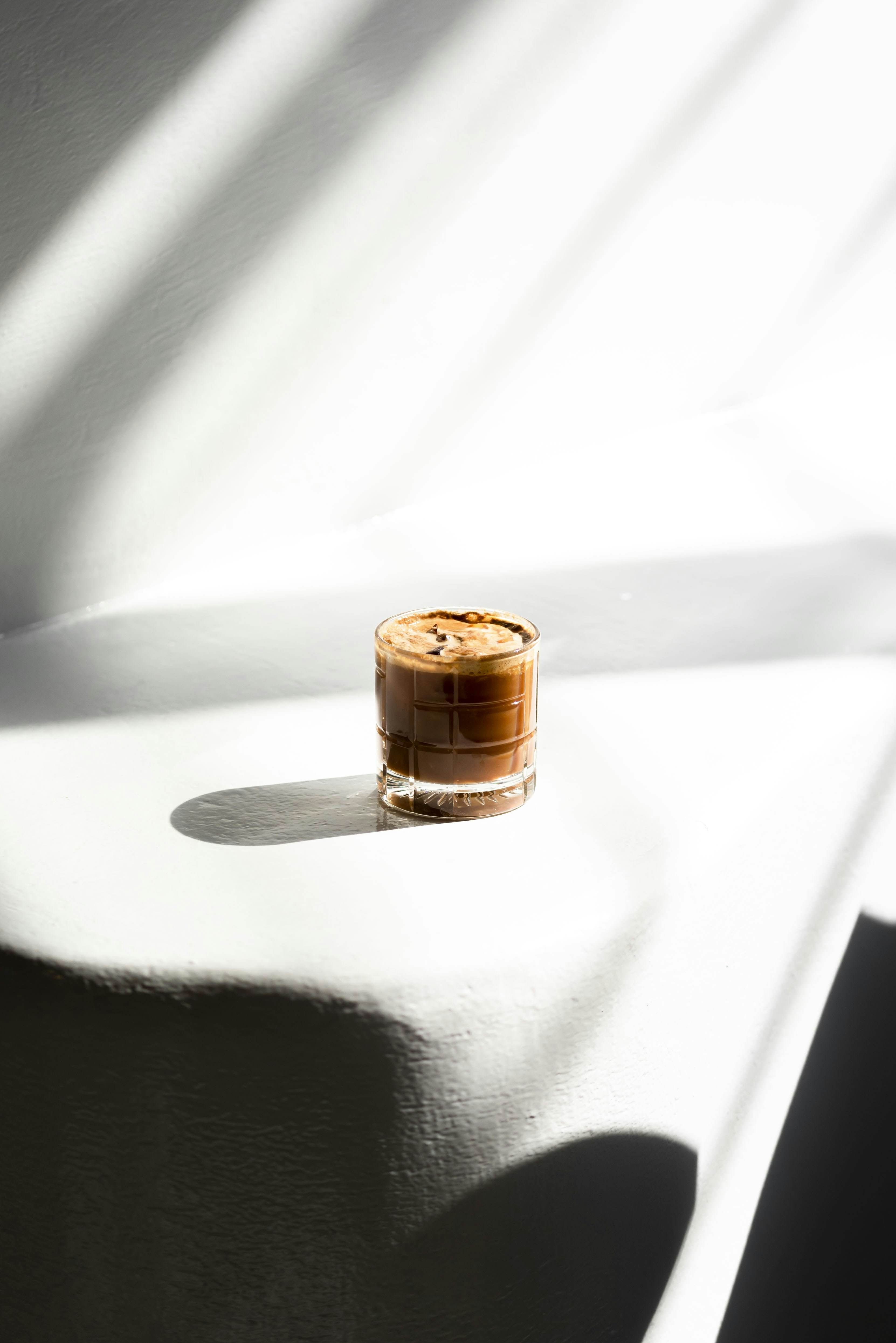 A small bottle of wine sitting on top of a white table