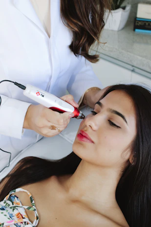 A woman getting her hair styled by a professional hair stylist