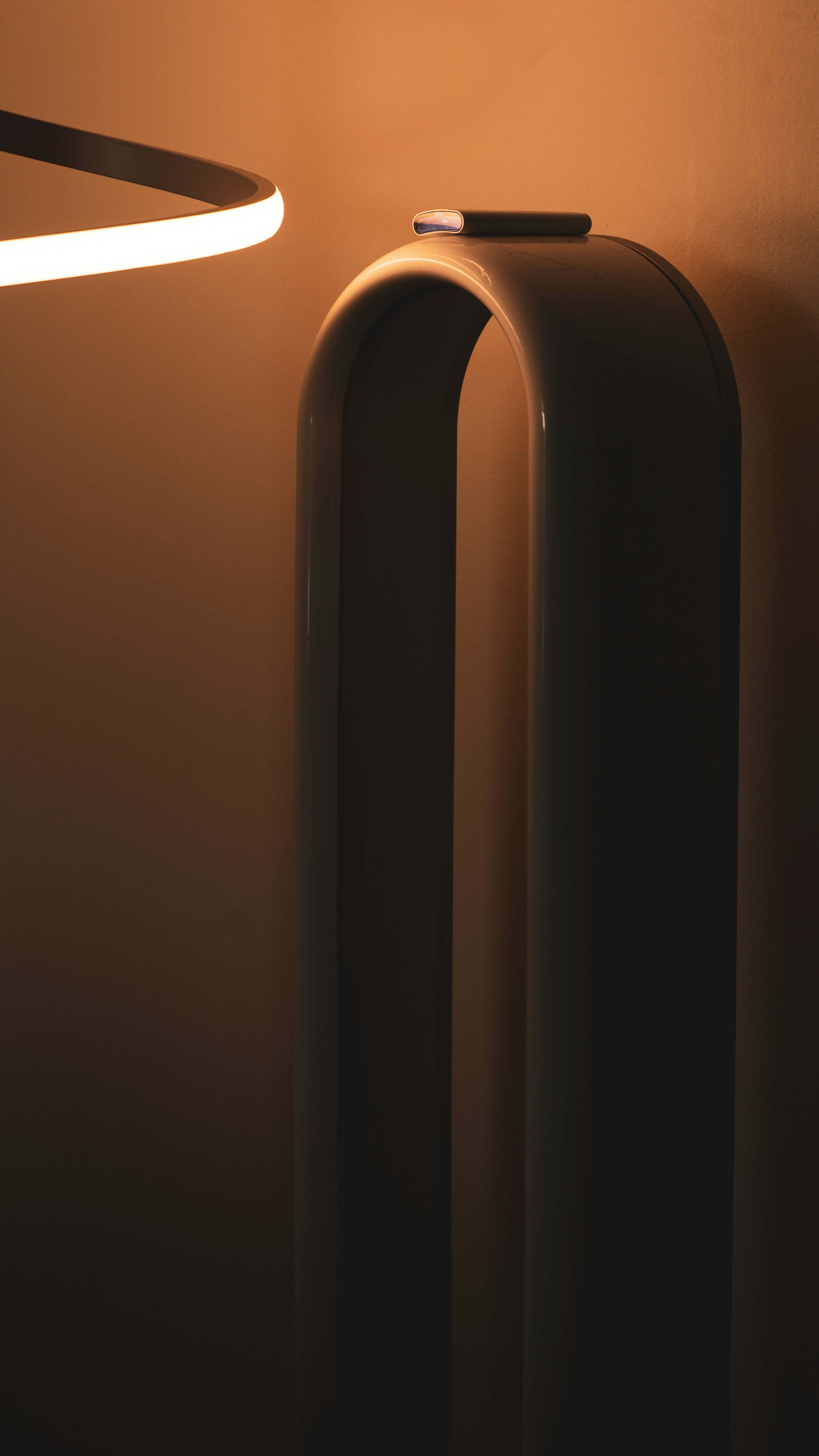 A lamp that is next to a wall