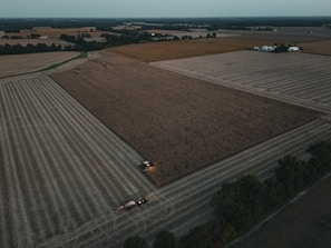 An aerial view of a farm field with a tractor