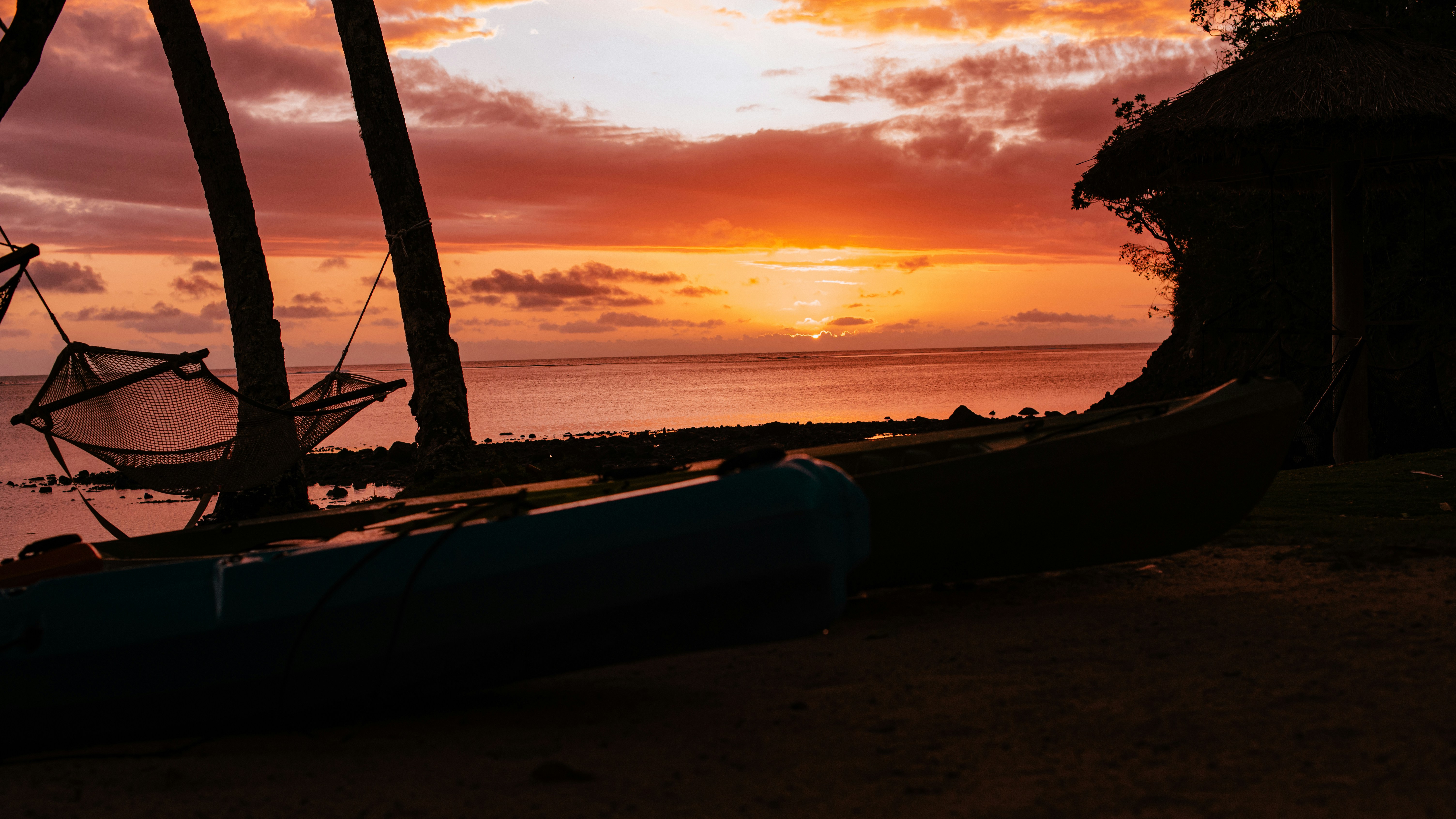 A boat sitting on top of a beach next to the ocean