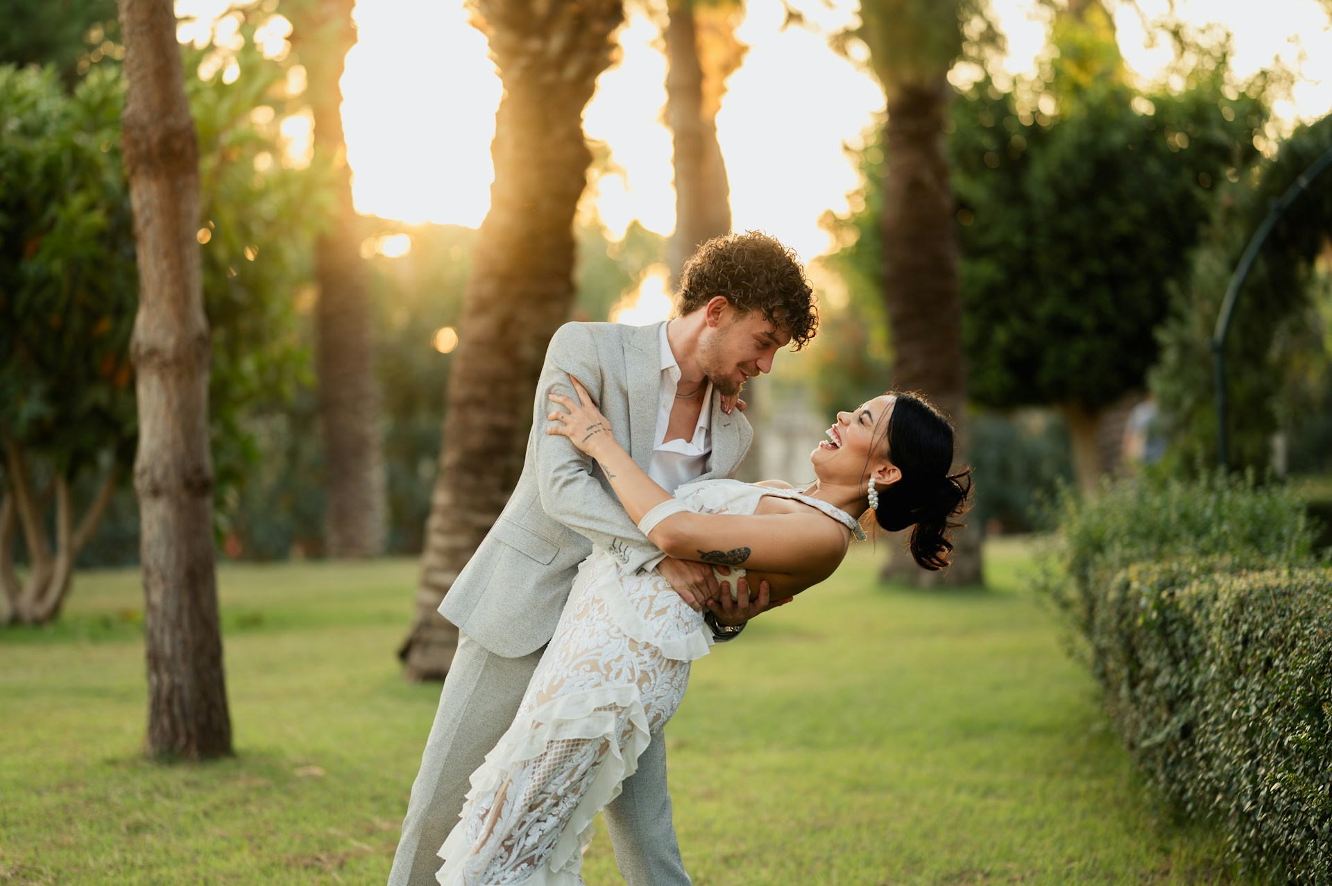 A man and a woman are dancing in the grass