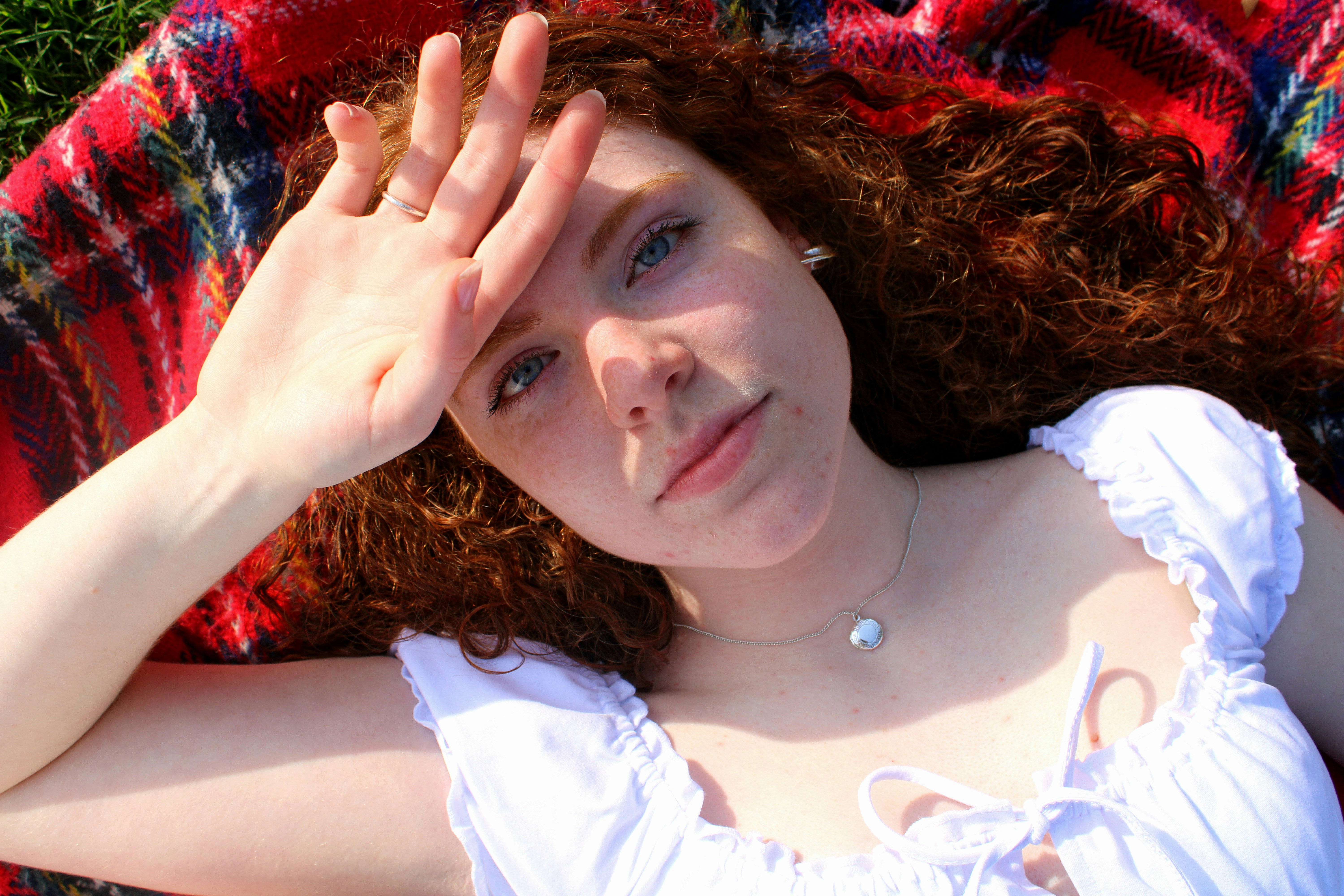 Red hair girl on picnic blanket