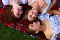 A group of people laying on top of a blanket