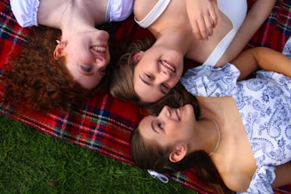 A group of people laying on top of a blanket