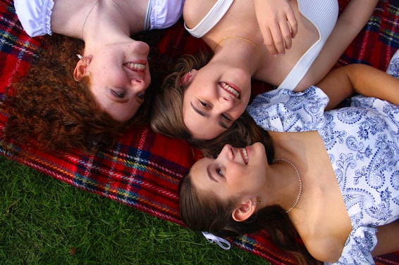 A group of people laying on top of a blanket