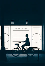 A person riding a bike in front of a store