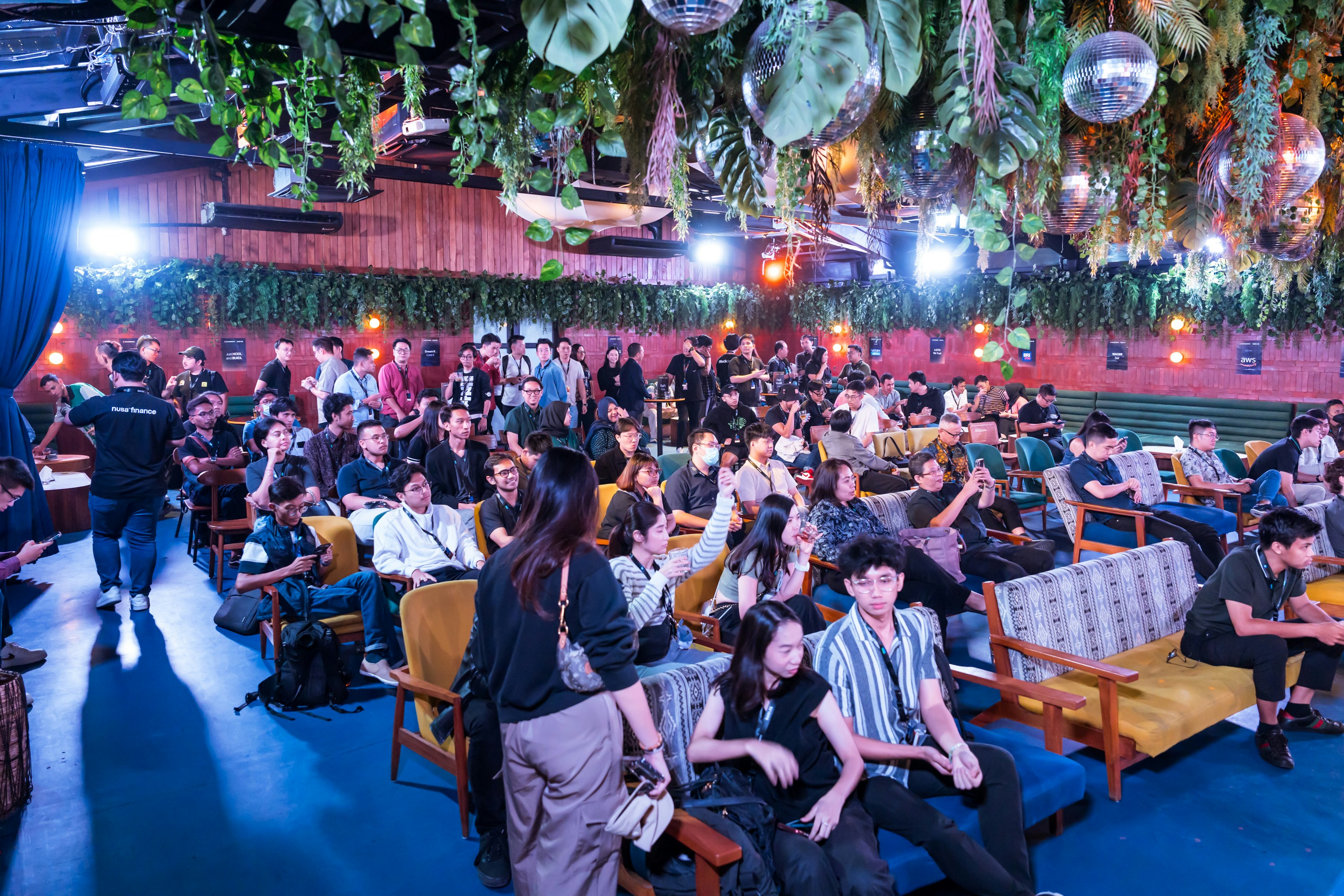 Miami entertainment venue with colorful lights and diverse LGBTQ+ crowd enjoying live performance