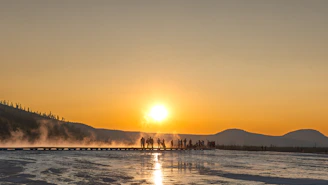 A group of people standing on top of a snow covered field