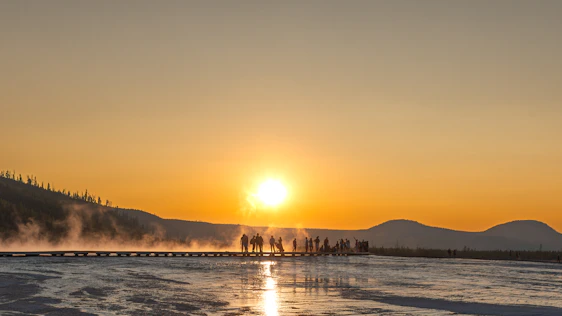 A group of people standing on top of a snow covered field