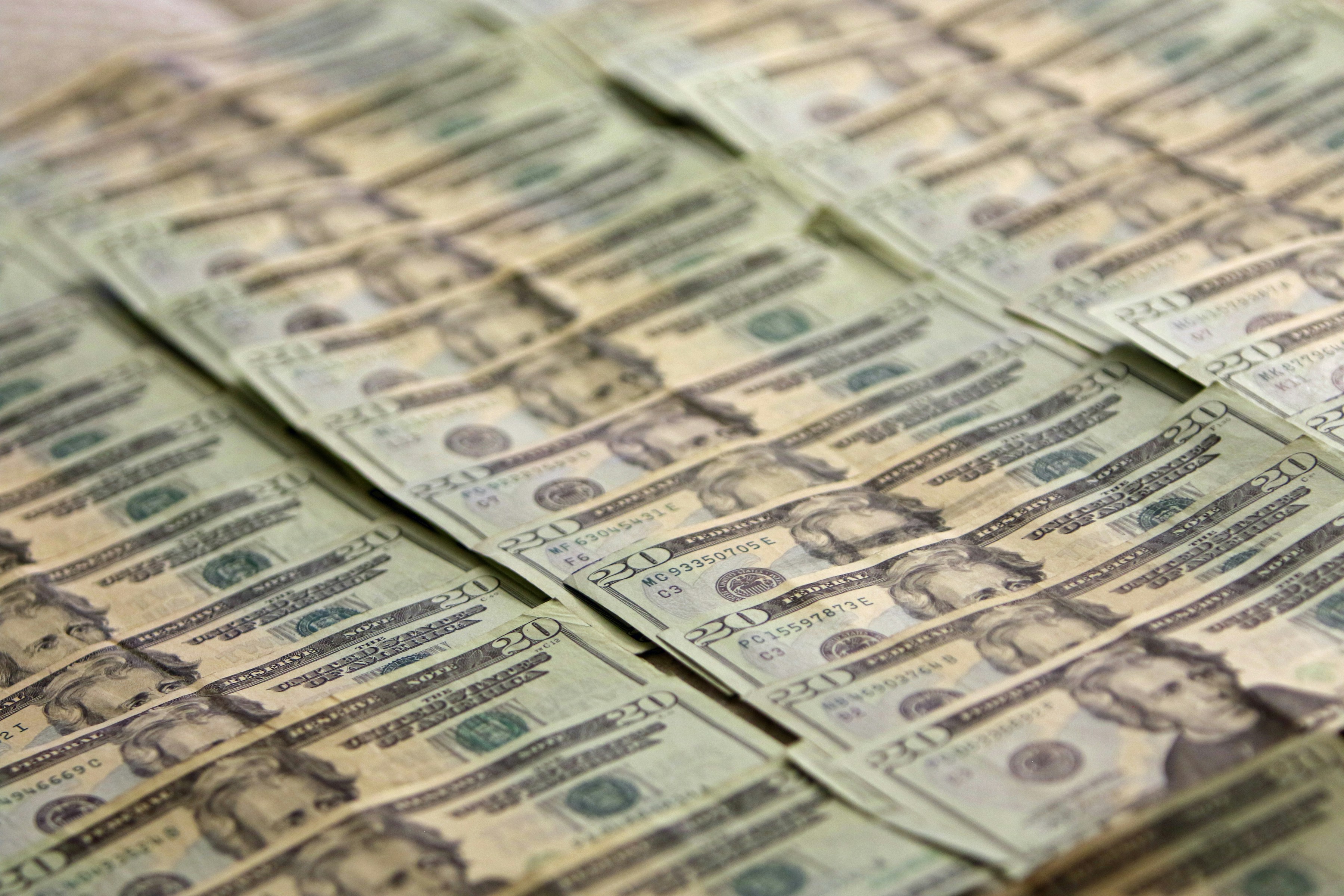 A pile of money sitting on top of a table