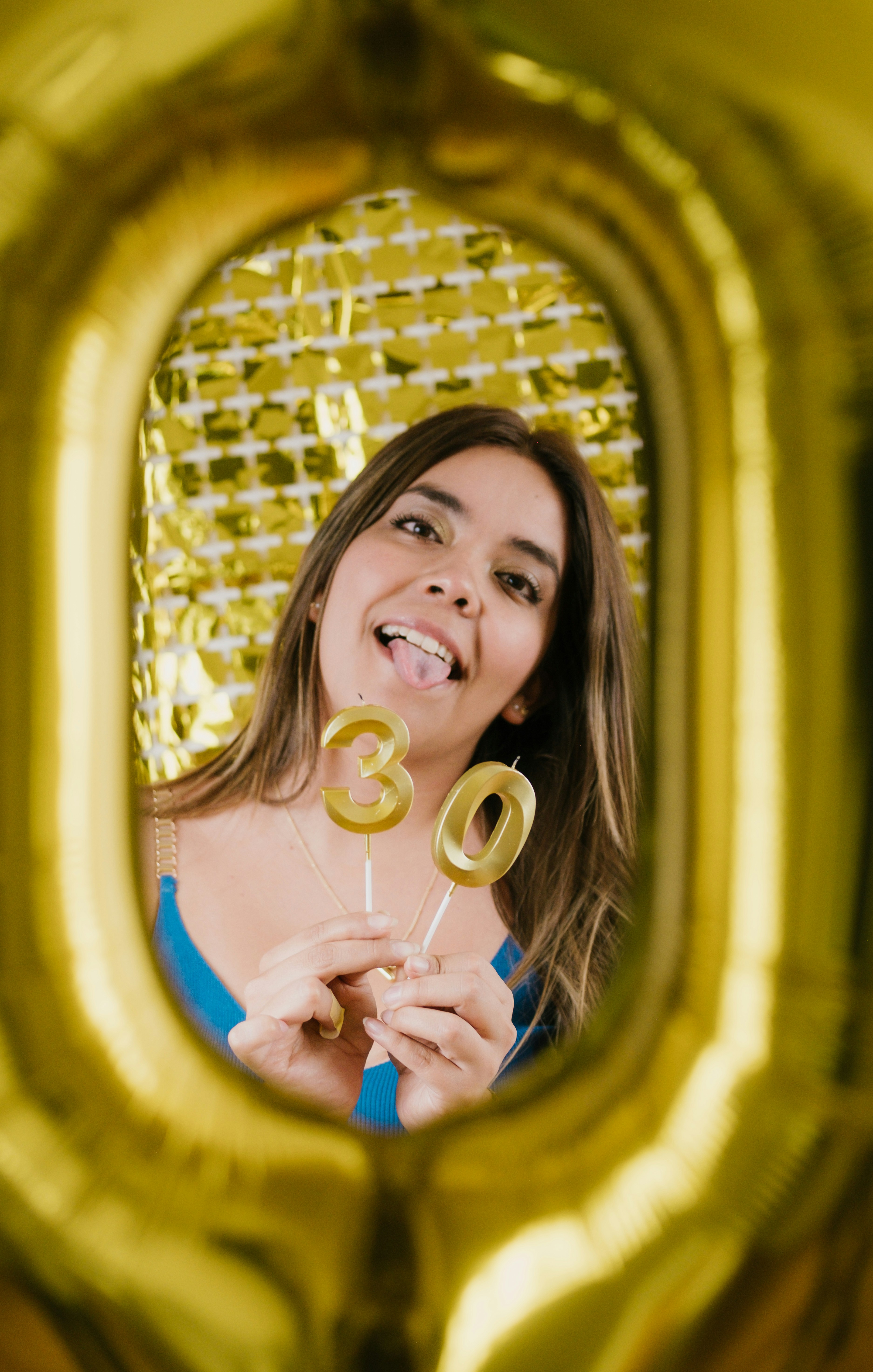 A woman holding a lollipop in front of a mirror