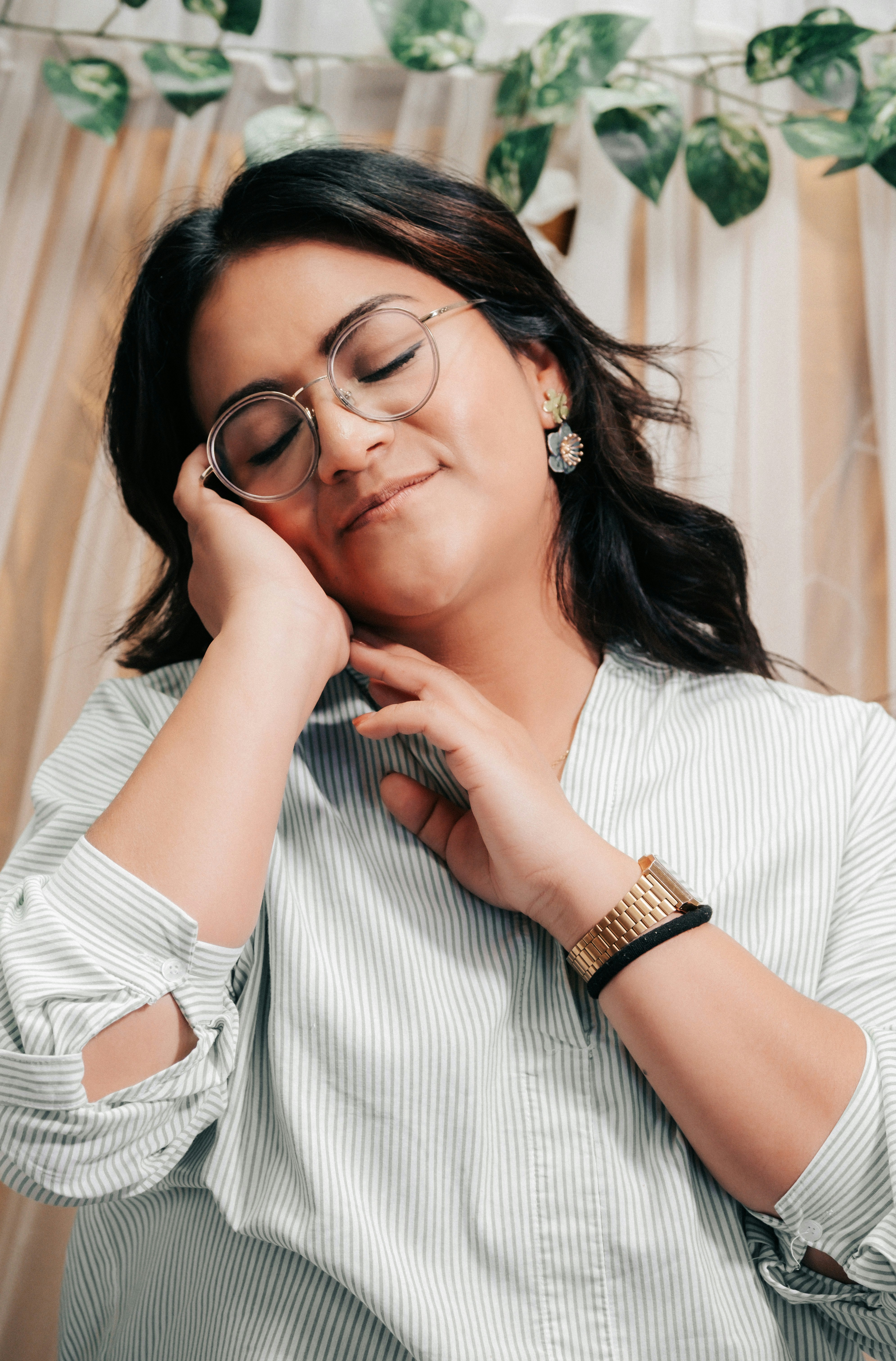 A woman wearing glasses is posing for a picture