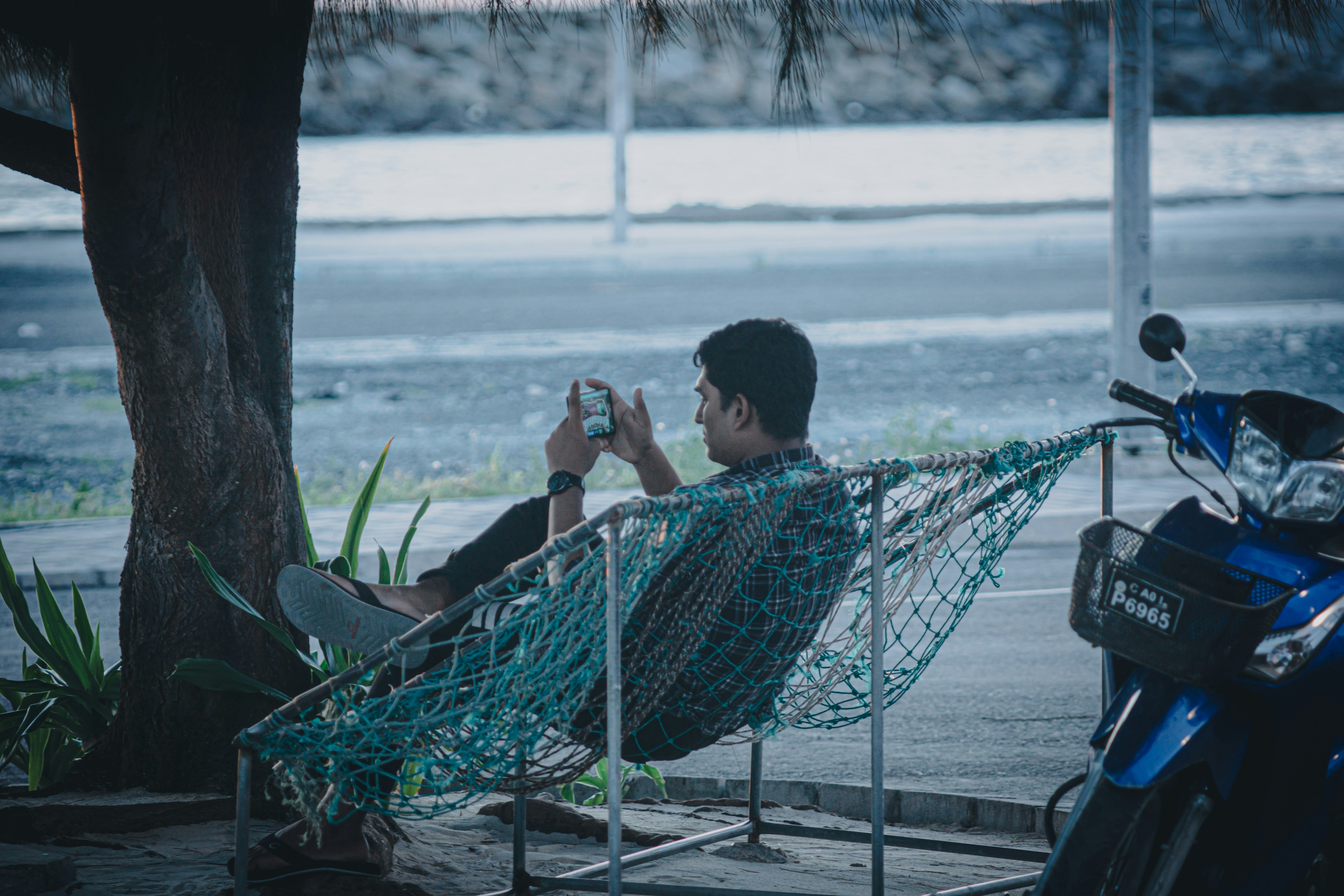 A man sitting in a chair next to a motorcycle
