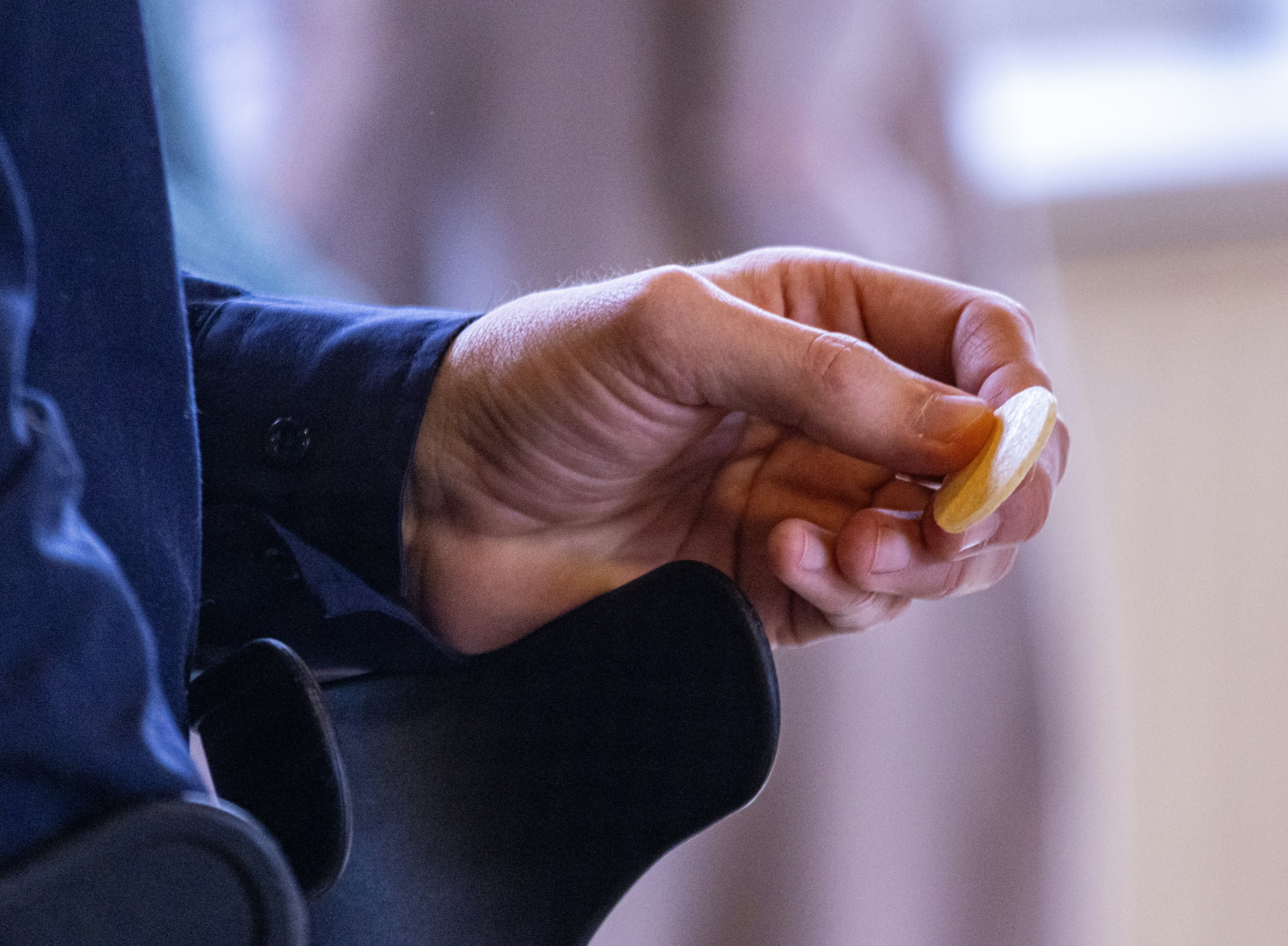 A person holding a piece of food in their hand