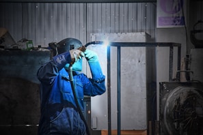 A man in a blue jacket holding a flashlight