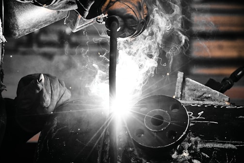 A welder working on a piece of metal