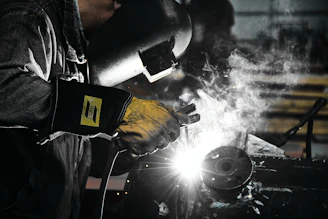 A welder working on a piece of metal