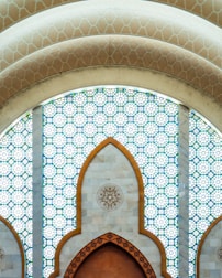 A large wooden door in front of a stained glass window
